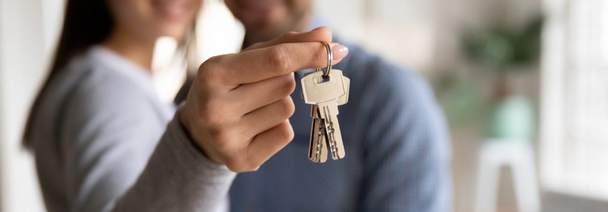 Homebuyers holding keys to their new home at Little Lane Carson.